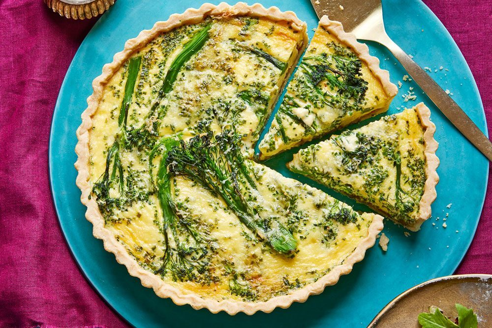 A finished, golden-brown quiche sliced and ready to serve.