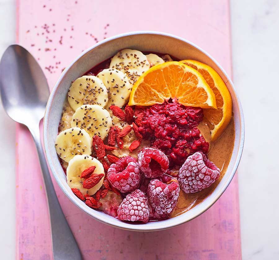 A beautiful breakfast bowl with chia pudding, fresh fruit, and seeds.