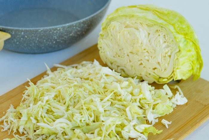Freshly chopped green cabbage on a cutting board