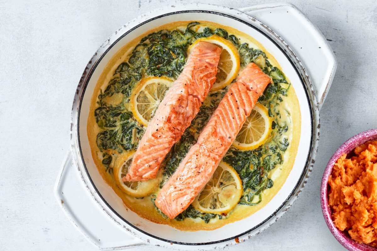 Creamy lemon garlic salmon with spinach in a skillet