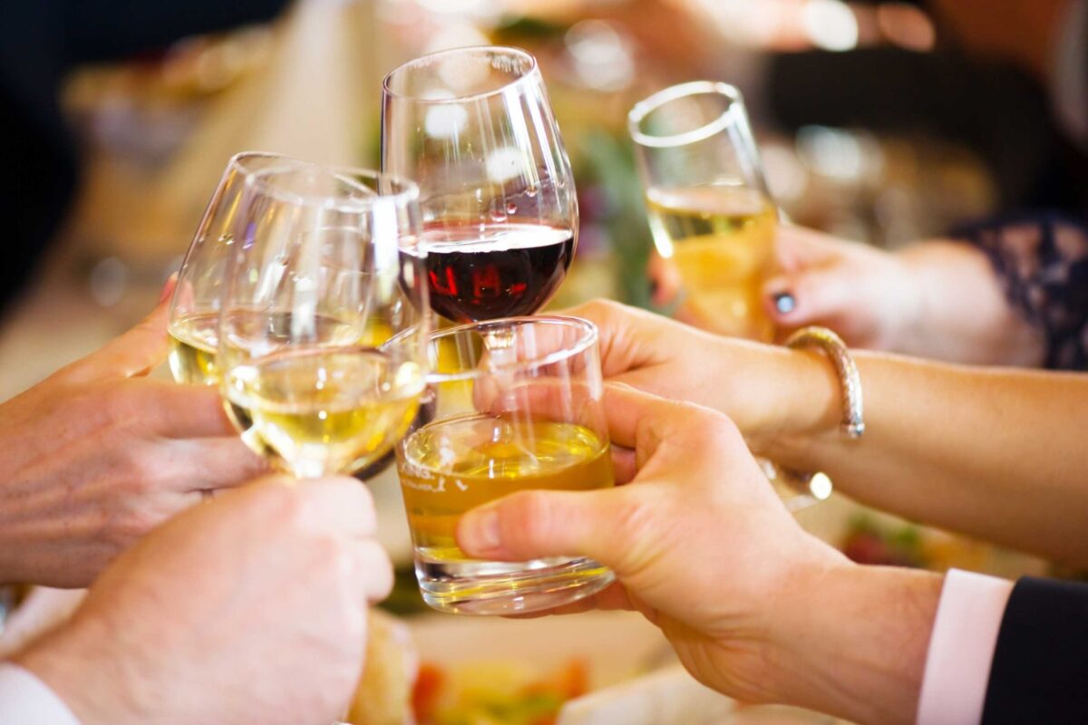 Two people toasting with glasses of wine.