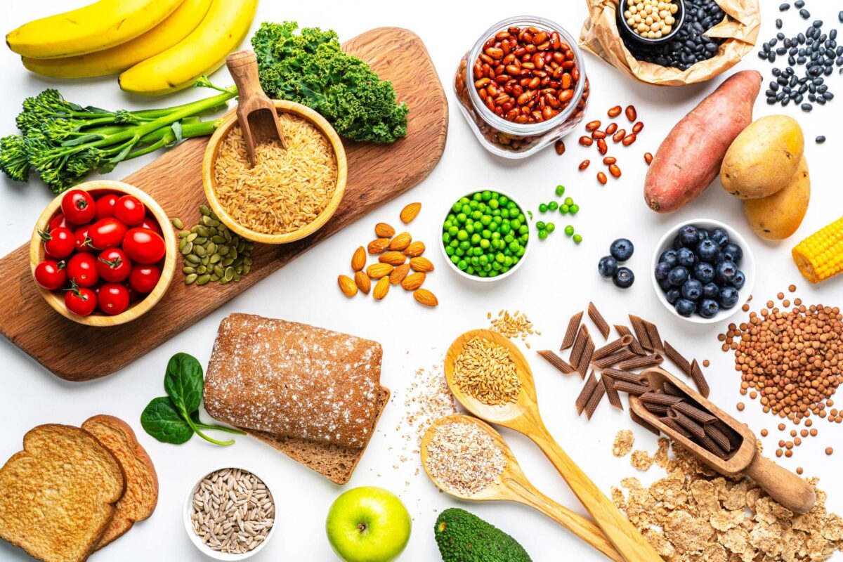 A collection of high-fibre foods including beans, nuts, seeds, and whole grains.