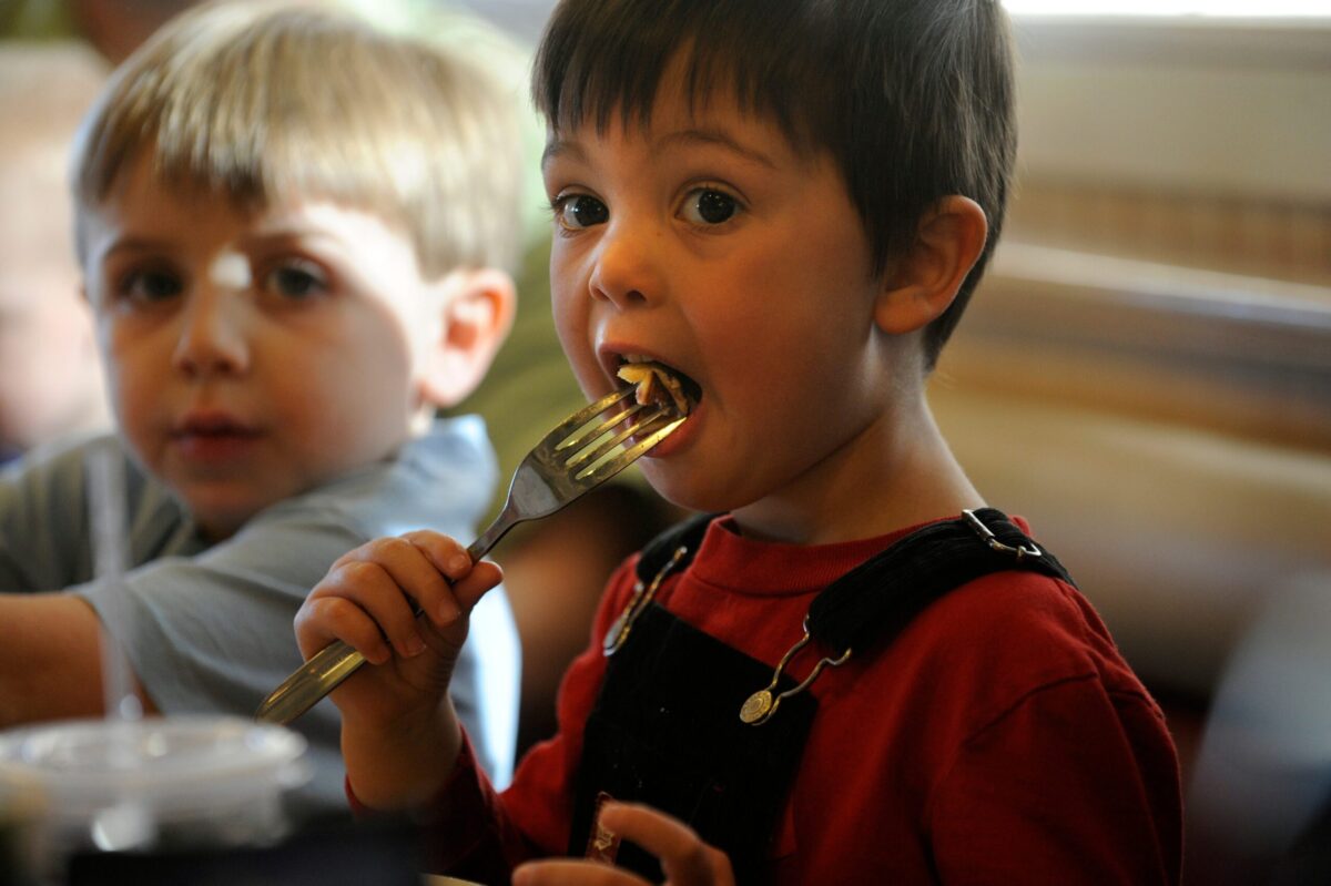 A happy child enjoying a family meal