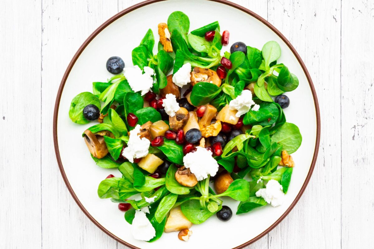 A vibrant, healthy salad in a white bowl.