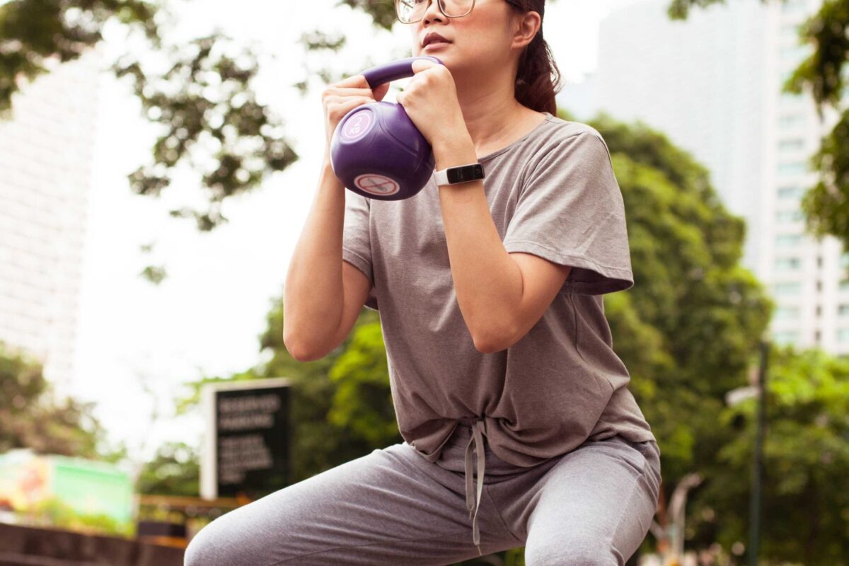 Woman performing a goblet squat with a kettlebell