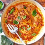 A skillet of creamy Marry Me Chicken garnished with fresh basil.