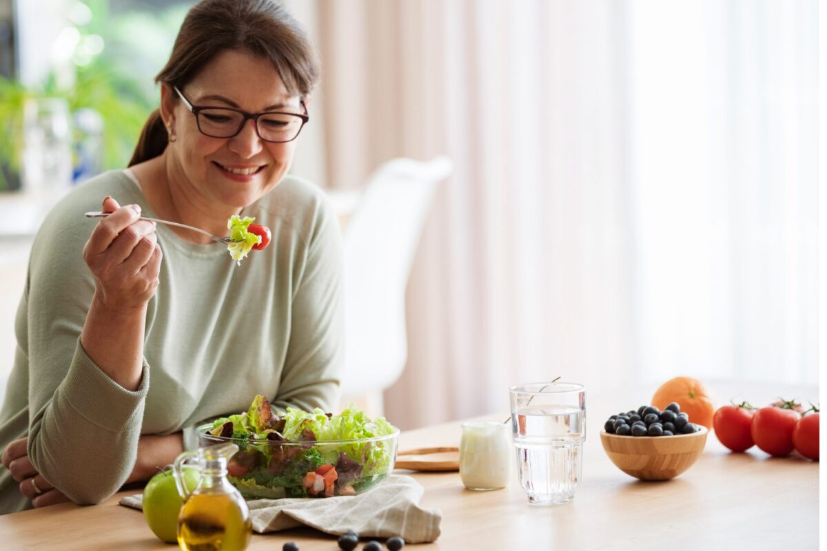 A woman in midlife enjoying a healthy meal.