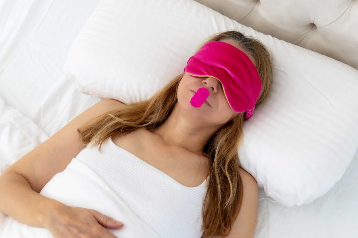 A woman with a small piece of tape correctly applied to her mouth for sleeping.