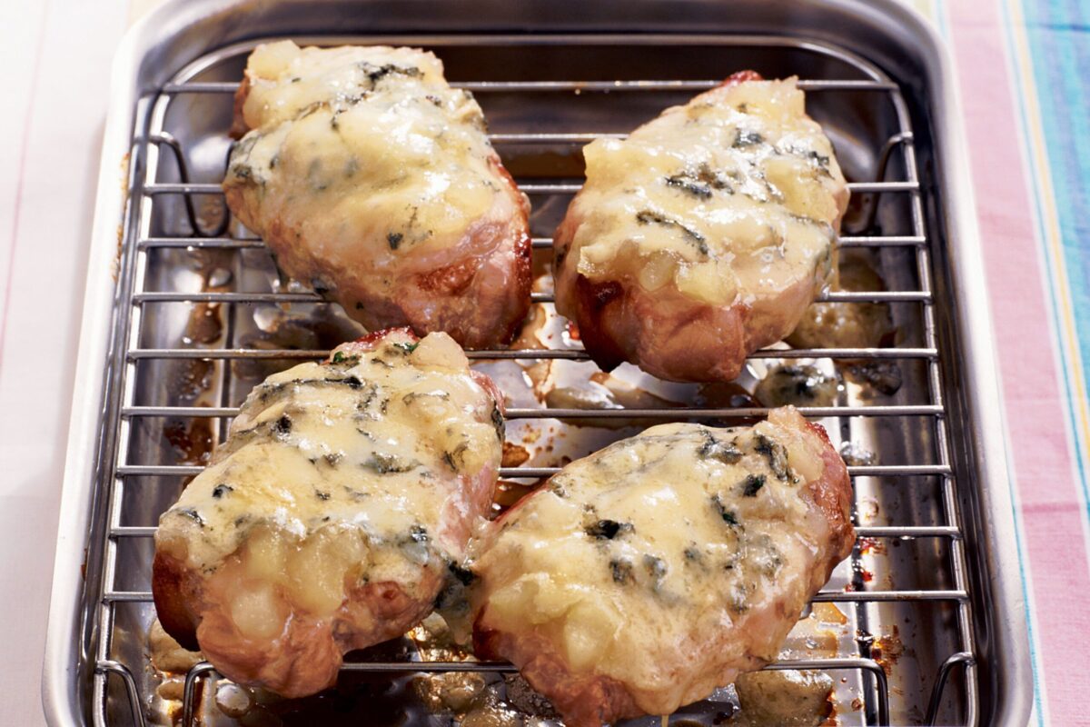Grilled pork chops covered in melted cheese
