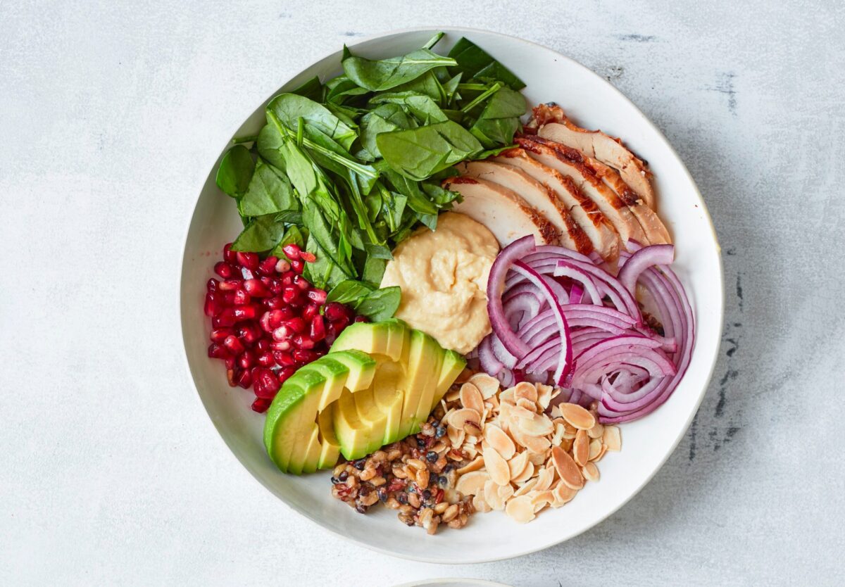 A quick and healthy bowl with chicken, hummus, and salad.