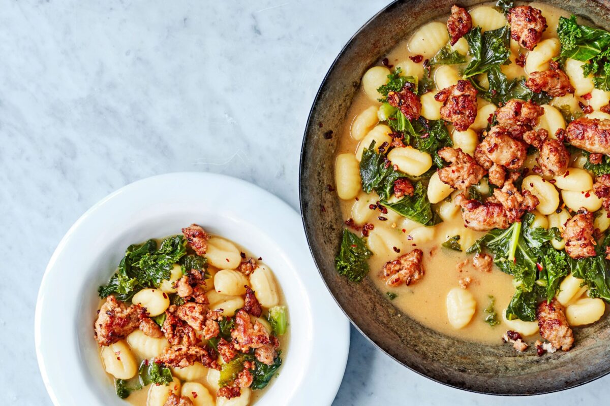 A hearty bowl of sausage, kale, and gnocchi one-pot