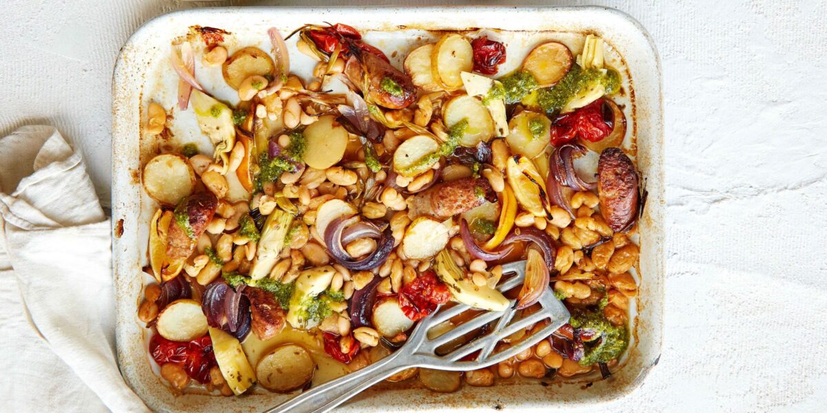 Sausage and vegetable traybake in a roasting pan
