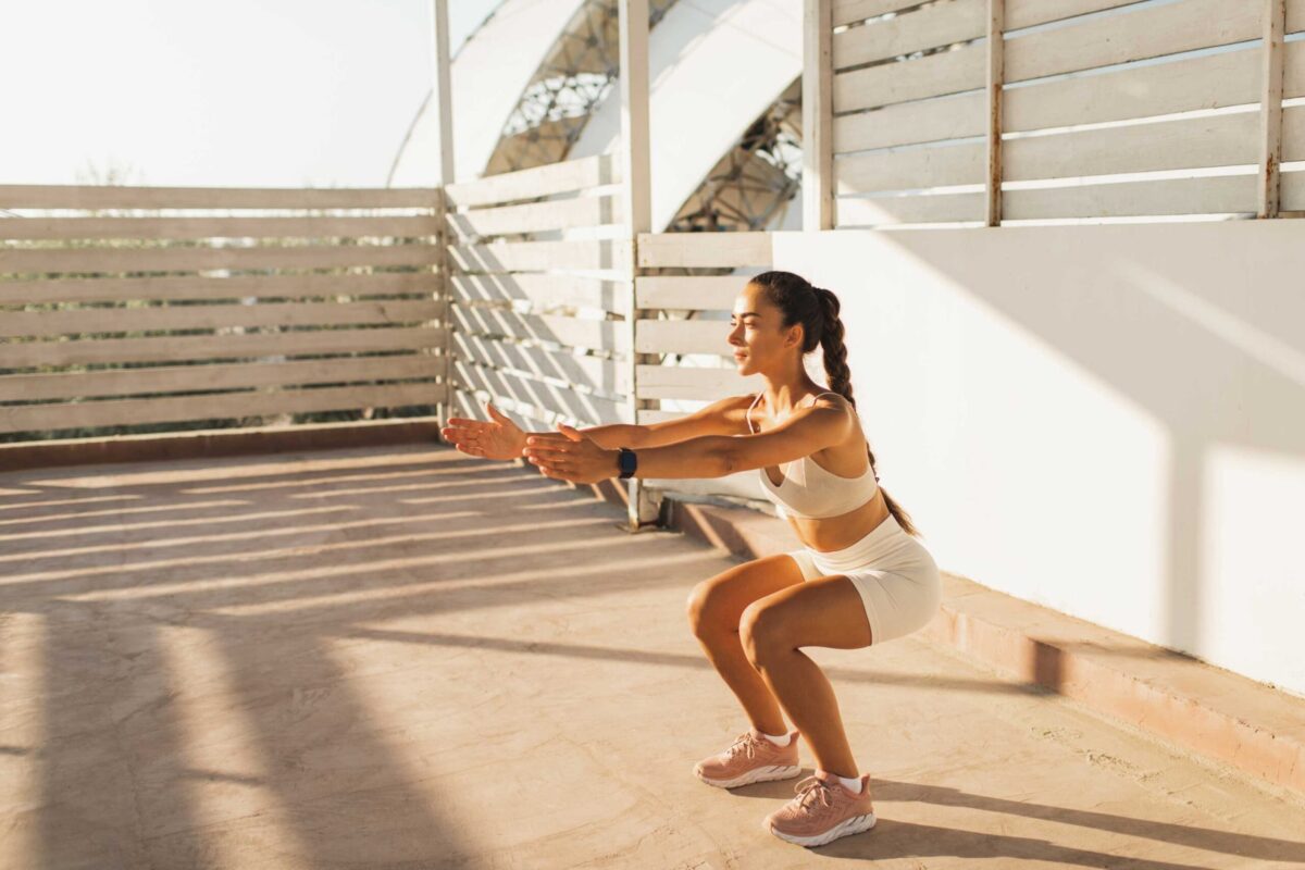 Woman doing a perfect squat outdoors