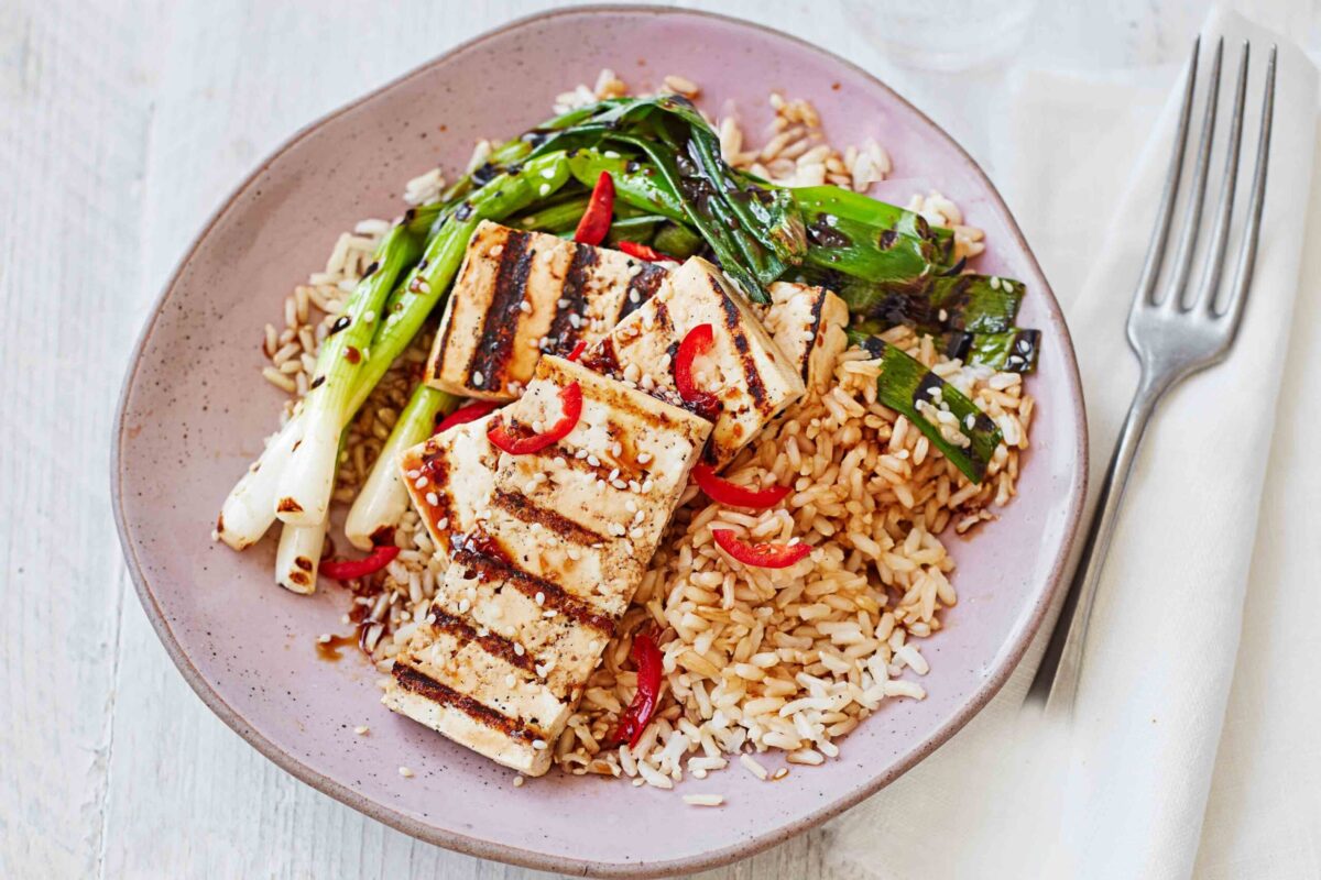 Teriyaki tofu with rice and charred spring onions in a bowl