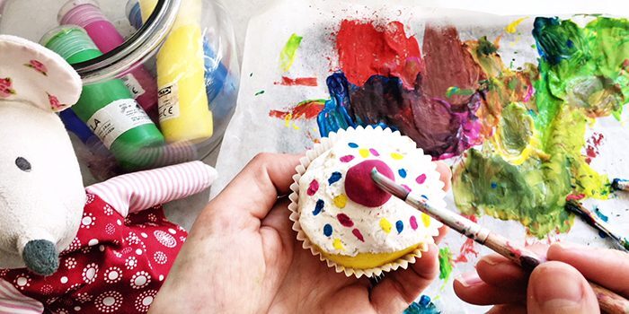Child painting a colorful salt dough creation