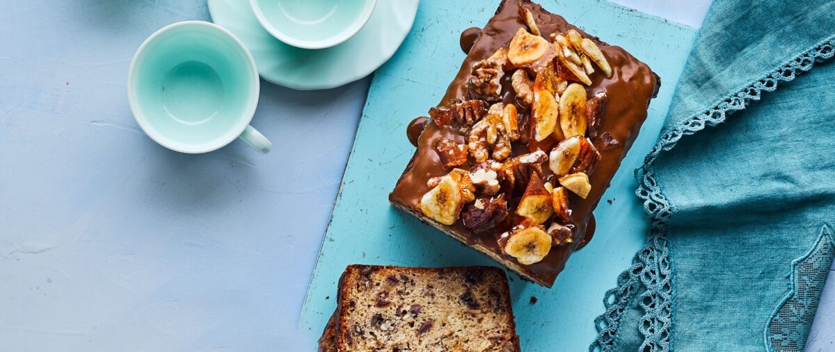 A loaf of sticky toffee banana bread with a decadent glaze.