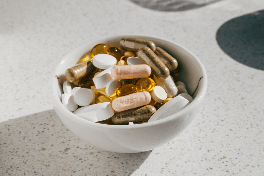 A bowl of supplements representing key nutrients for skin health