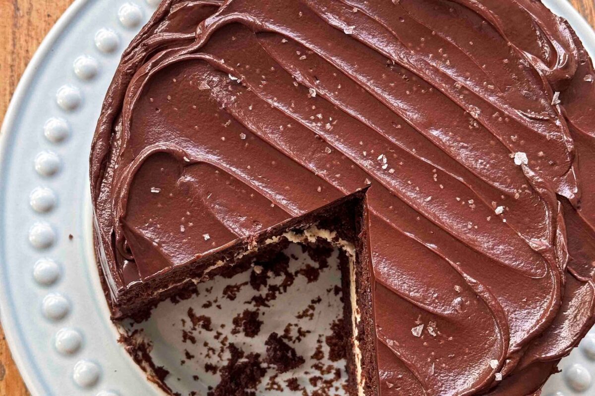 A slice of rich chocolate fudge cake with mascarpone filling and ganache icing