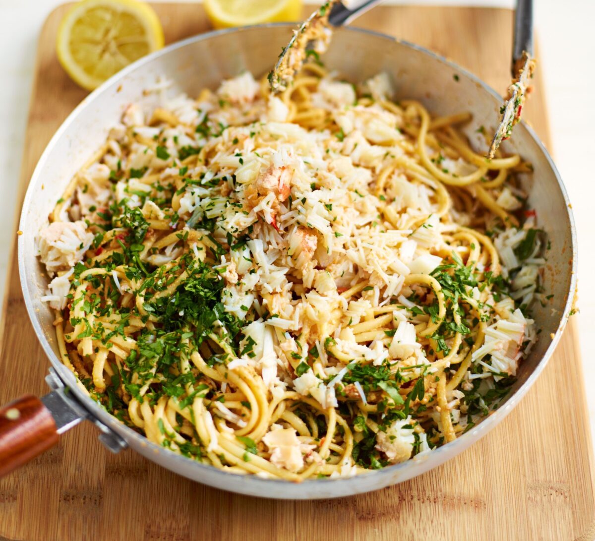A pan of crab linguine with fresh parsley and chilli