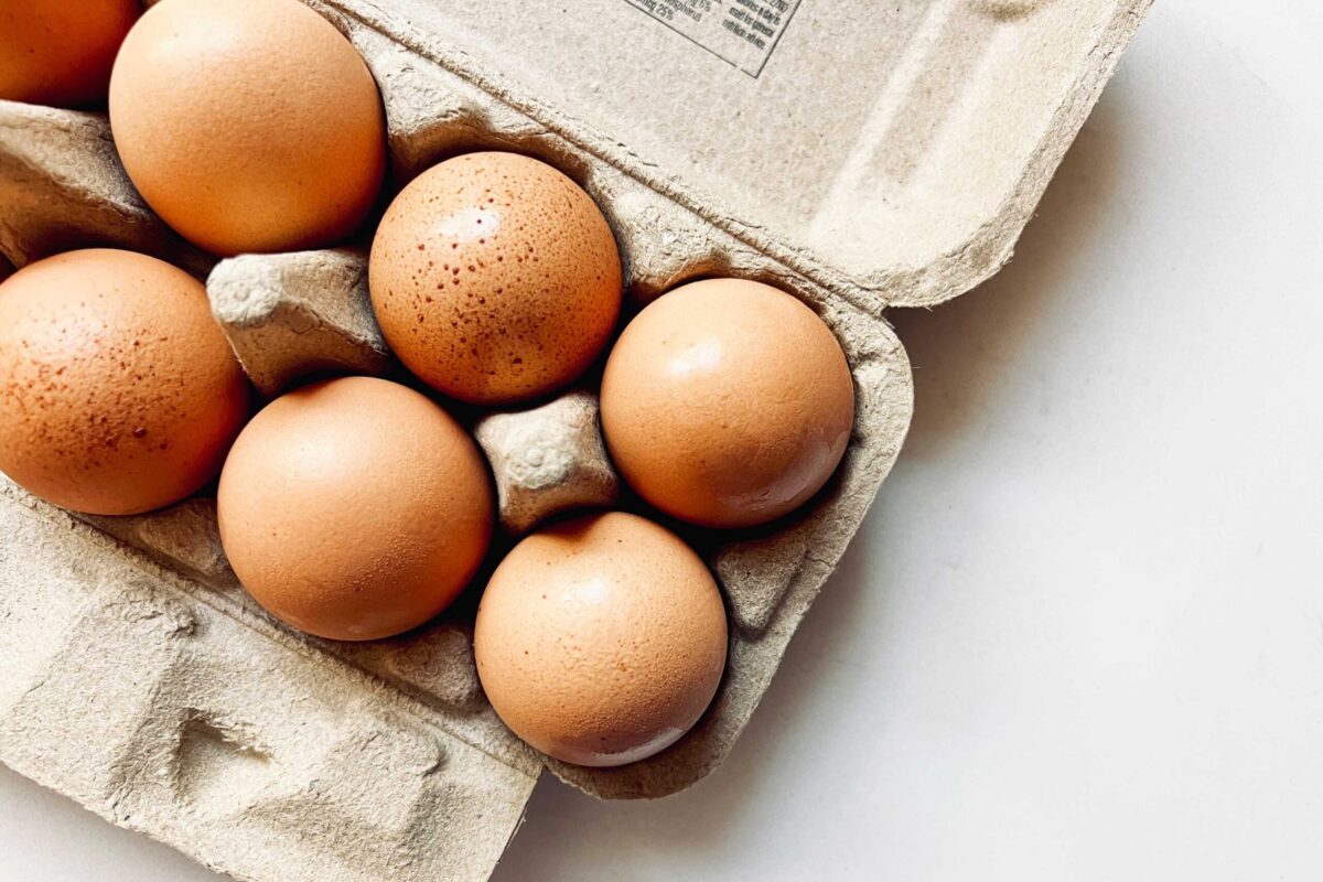Brown and white eggs in a carton