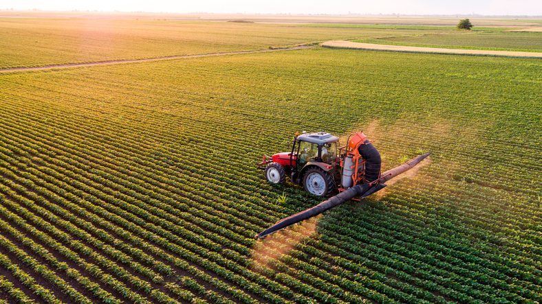 An aerial view of a tractor farming a field, symbolizing wholesome ingredients.