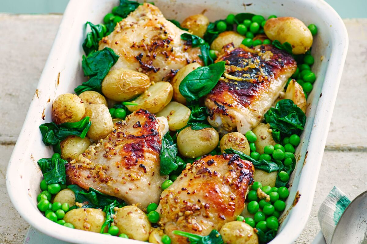 Honey and mustard chicken thighs in a traybake with spring vegetables