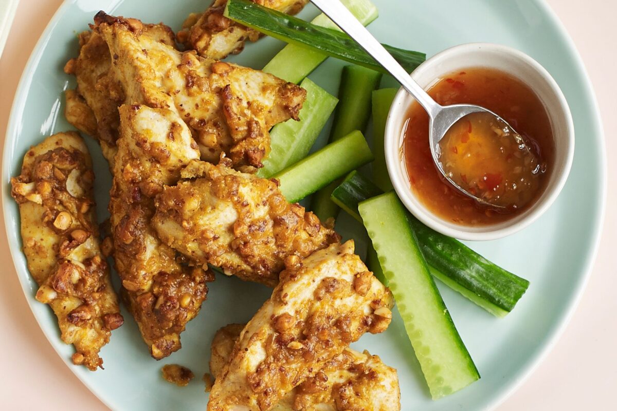 Delicious nutty chicken satay strips on a plate