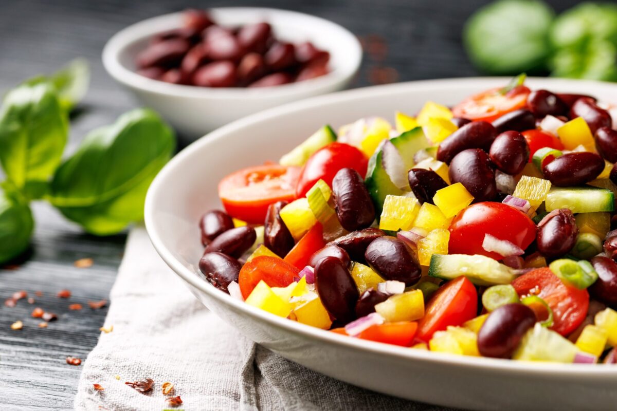 A fresh salad topped with kidney beans.