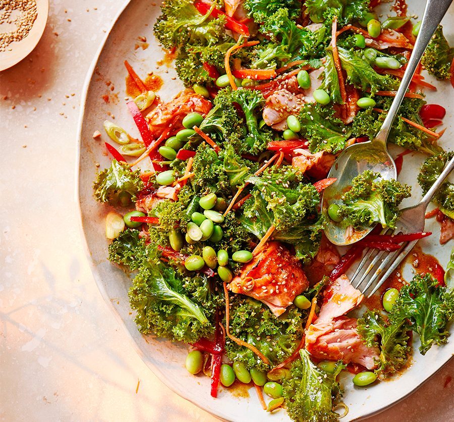 Spicy miso salmon & kale salad served on an oval plate