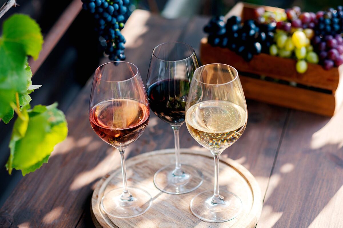 A collection of non-alcoholic wine bottles and glasses.