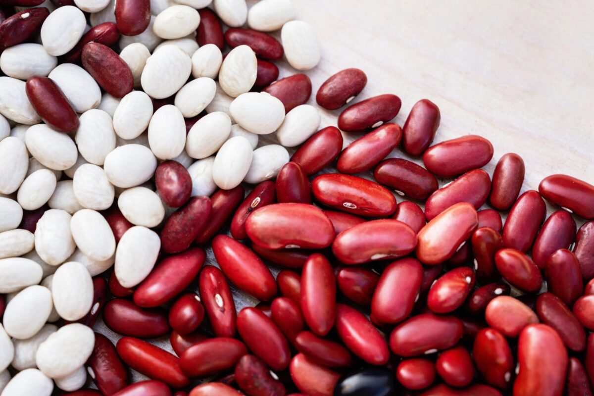 A bowl of red and white kidney beans side-by-side.